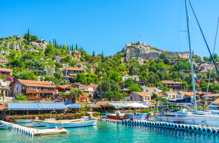 KALEKOY, TURKEY - MAY 5, 2017: Kekova bay ais famous for the small settlements on its coast, offering perfect tourist service, comfortable beaches, boat and yacht trips, tasty cuisine, on May 5 in Kalekoy.のeditorial素材