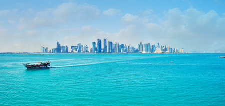 DOHA, QATAR - FEBRUARY 13, 2018: The seascape of Persian Gulf with iconic skyline of Doha - glass...