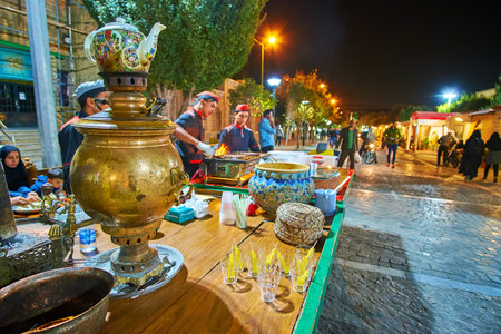 TEHRAN, IRAN - OCTOBER 25, 2017: Cafe in Tehran street fair offers hot tea from samovar with traditional sugar candy, on October 24 in Tehranのeditorial素材