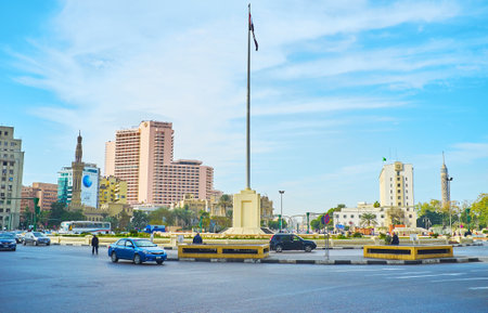 CAIRO, EGYPT - DECEMBER 24, 2017: The giant flag waving in the middle of busy Midan Al Tahrir (Martyrs Square), on December 24 in Cairo.のeditorial素材