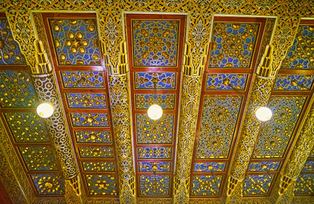CAIRO, EGYPT - DECEMBER 24, 2017: The complex carved ceiling of living room in Manial Palace, covered with golden and silver paint and inlays, on December 24 in Cairo.のeditorial素材