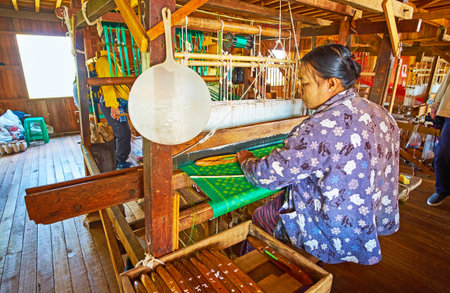 INPAWKHON, MYANMAR - FEBRUARY 18, 2018: Textile workshops on Inle lake are famous for the high quality handmade fabrics of cotton, silk and lotus, produced by locals, on February 18 in Inpawkhon.のeditorial素材