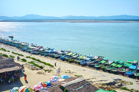 BAGAN, MYANMAR - FEBRUARY 24, 2018: The long line of moored boats in small rural port on Irrawaddy river, on February 24 in Baganのeditorial素材