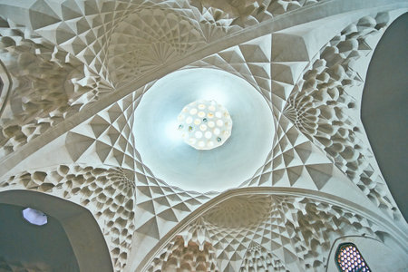 KERMAN, IRAN - OCTOBER 15, 2017: Relief dome of Ganjali Khan Bathhouse with beautiful honeycomb arches and stellar carved patterns, on October 15 in Kerman.のeditorial素材