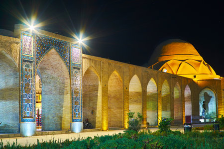 The Square of Ganjali Khan look great in the evening with brightly illuminated arcades and tiled portals, Kerman, Iran.のeditorial素材