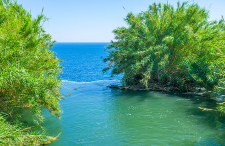 The edge of the cliff at the point of water flowing, creating Lower Duden Waterfall, dropping...