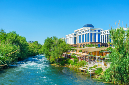 The luxury tourist hotel is located next to the Lower Duden Waterfall and has scenic summer restaurant on bank of Duden river, Antalya, Turkeyの写真素材