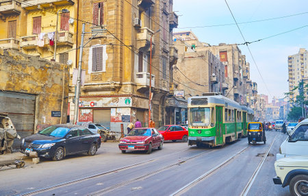 ALEXANDRIA, EGYPT - DECEMBER 18, 2017: The old green tram of Al Madina line drives along the shabby...