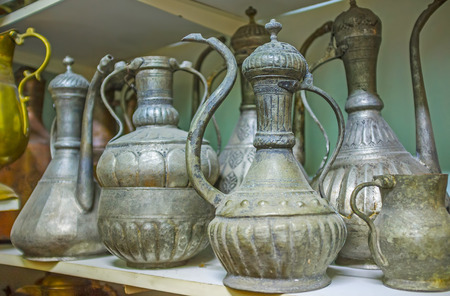Hand chased dallah coffee pots in antique store of Old Bazaar in Antalya, Turkey.の写真素材