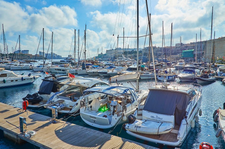 VALLETTA, MALTA - JUNE 17, 2018: The scenic yachts, moored in Marina of Valletta with medieval rampart on the background, on June 17 in Valletta.のeditorial素材