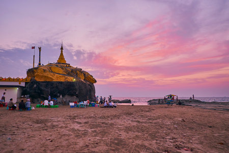 CHAUNG THA, MYANMAR - FEBRUARY 28, 2018: The picturesque sunset over the Kyauk Pa Hto Pagoda,...