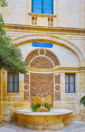 VALLETTA, MALTA - JUNE 17, 2018: The Prince Alfred's Courtyard of Grandmaster's Palace boasts scenic Bird Fountain, hidden behind the trees of the garden, on June 17 in Valletta.のeditorial素材