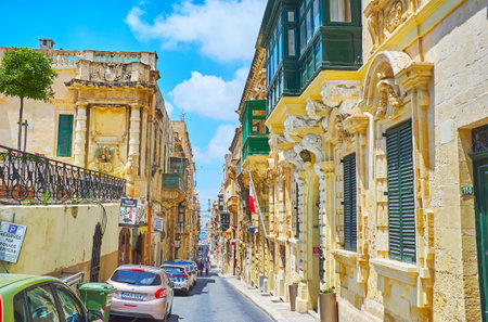 VALLETTA, MALTA - JUNE 17, 2018: The scenic mansions of Archbishop street with carved stucco decorations, relief patterns and Maltese balconies, on June 17 in Vallettaのeditorial素材