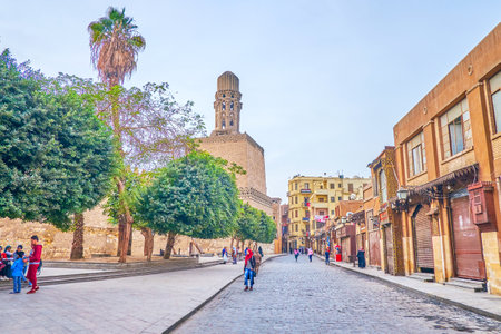 CAIRO, EGYPT - DECEMBER 23, 2017: The early morning in Al-Muizz Street with closed shops, cafes and walking teenagers, on December 23 in Cairoのeditorial素材