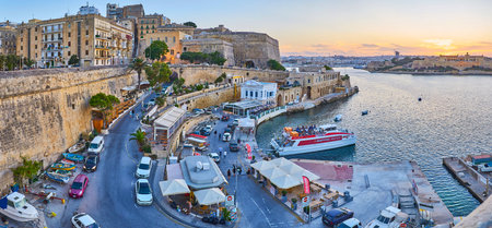 VALLETTA, MALTA - JUNE 17, 2018: The evening view on city walls, St Andrew's Bastion, curved streets and ferry terminal at Marsamxett Harbour, on June 17 in Valletta.のeditorial素材