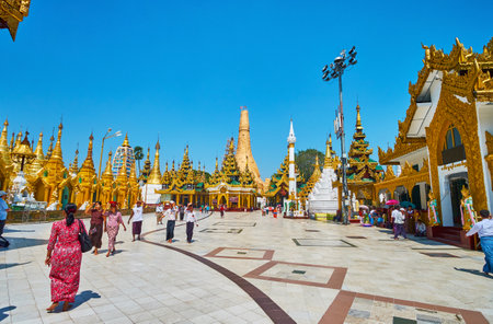 YANGON, MYANMAR - FEBRUARY 27, 2018: The stupas and image houses of Northern-East corner of Shwedagon Pagoda with intericate gilt decorations, fine plasterwork and taditional pyatthat roofs, on February 27 in Yangon.のeditorial素材