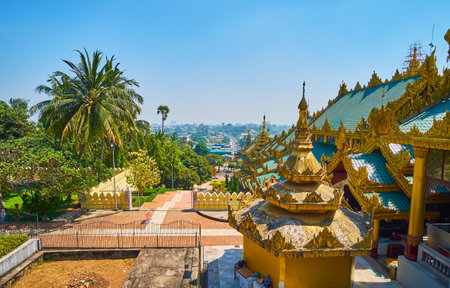 The roof of Eastern stairway of Shwedagon Zedi Daw and the lush green garden, occupying the slope of Singuttara Hill, Yangon, Myanmar.のeditorial素材