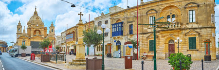 NADUR, MALTA - JUNE 15, 2018: Panorama of the Market square with old edifices, stone Cross (Salib tad-Dejma) and great St Peter and Paul's Basilica, on June 15 in Nadur.のeditorial素材