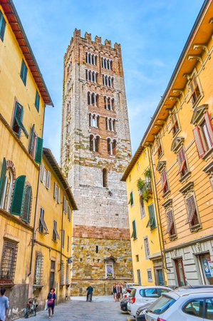 LUCCA, ITALY - APRIL 30, 2013: The view on high bell tower of San Ferdiano Basilica with arched windows on its floors, on April 30 in Luccaのeditorial素材