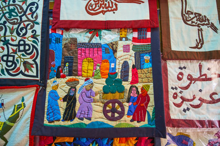 CAIRO, EGYPT - DECEMBER 21, 2017:  The appliqued pillowcase in shop of Tentmakers alley (Sharia Khayamiya), depicting the scene on Arabic Bazaar, on December 21 in Cairo, Egypt.のeditorial素材