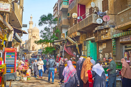 CAIRO, EGYPT - DECEMBER 21, 2017: The crowded Al Khayama street with many food stalls and medieval Prince Gani Bek mosque on the background, on December 21 in Cairo.のeditorial素材
