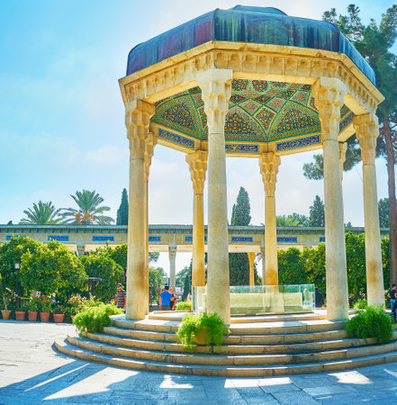 SHIRAZ, IRAN - OCTOBER 13, 2017: Beautiful stone pavilion, decorated with muqarnas, slender columns and tiled dome, covers the tomb of Hafez - famous Persian poet, Mussala Gardens, on October 13 in Shiraz.のeditorial素材