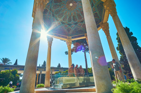 SHIRAZ, IRAN - OCTOBER 13, 2017: The group of Iranian soldiers visits the Mausoleum of Hafez, making pictures at the Tomb of famous poet in ornate pavilion, on October 13 in Shiraz.のeditorial素材