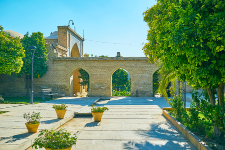 The brick fence with arched passes separates Mussala Gardens from the Hafezieh courtyard, Shiraz, Iran.の写真素材