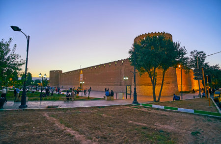 SHIRAZ, IRAN - OCTOBER 14, 2017: People walk around Shohada Square with a view on old Karim Khan citadel on twilight, on October 14 in Shiraz.のeditorial素材
