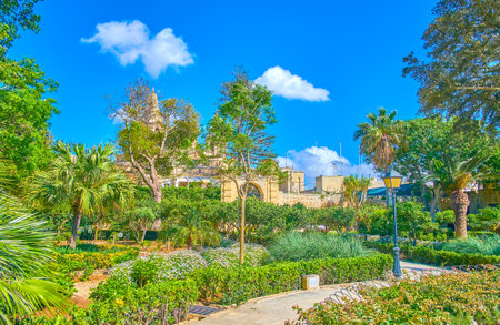 NAXXAR, MALTA - JUNE 14, 2018: The alleys in garden of Palazzo Parisio, surrounded with lush greenery, on June 14 in Naxxar.のeditorial素材