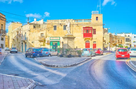 NAXXAR, MALTA - JUNE 14, 2018: The crossroad in small town with sculpture of Righteous Joseph with a child in the middle, on June 14 in Naxxar.のeditorial素材