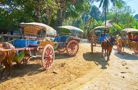 AVA, MYANMAR - FEBRUARY 21, 2018: The horse-drawn carts offer the tour around the ancient imperial capital of Burmese kingdoms, on February 21 in Ava.のeditorial素材