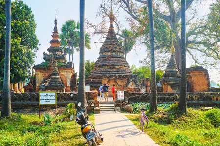 AVA, MYANMAR - FEBRUARY 21, 2018: The ancient brick complex of Yadana Hsemee Pagoda (Yandana Sinme) with preserved carved stupas, image houses and shrines, on February 21 in Ava.のeditorial素材