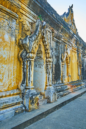 The carved wall and traditional Burmese doorframe of historic Maha Aungmye Bonzan Monastery, Ava, Myanmar.の写真素材