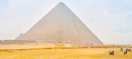 GIZA, EGYPT - DECEMBER 20, 2017: The beautiful view on Pyramid of Menkaure with walking tourists and...