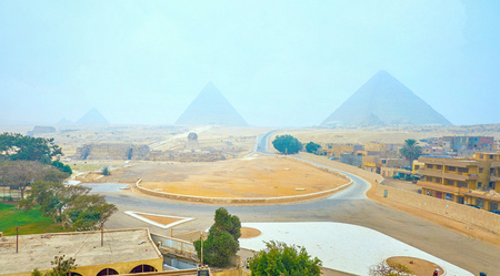 Foggy panorama of Pyramids and Sphinx in Giza Necropolis, located among the desert sands, this unique site attracts tourists all over the world, Egyptの写真素材