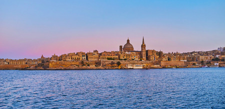 Enjoy historic Valletta city from the Northern Harbour, observe its tall belfries, huge domes and historic edifices behind the city wall, Malta.の写真素材