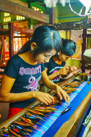 MANDALAY, MYANMAR - FEBRUARY 21, 2018: The artisans work with colorful silk threads at the handloom, on February 21 in Mandalay.のeditorial素材