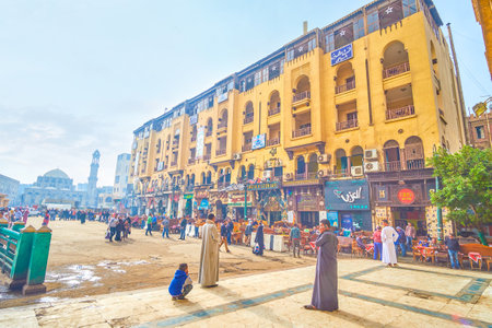 CAIRO, EGYPT - DECEMBER 20, 2017: The line of tourist restaurants in ground floor of historical edifice in busy Midan Hussein Square, on December 20 in Cairo.のeditorial素材