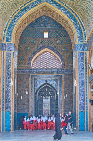YAZD, IRAN - OCTOBER 18, 2017: The group of Iranian schoolgirls visits medieval Jameh Mosque, richly decorated with patterns of glazed tiles, on October 18 in Yazd.のeditorial素材