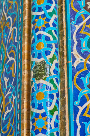 YAZD, IRAN - OCTOBER 18, 2017: The close-up of the slender column of Jameh Mosque's mihrab with fine Islamic patterns of tiles and intricate calligraphy in octagonal star in the middle, on October 18 in Yazd.のeditorial素材