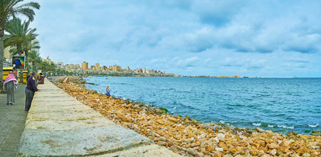 ALEXANDRIA, EGYPT - DECEMBER 19, 2017: Panorama of the long coastline of the city and line of palm trees in Corniche Avenue, on December 19 in Alexandria.のeditorial素材