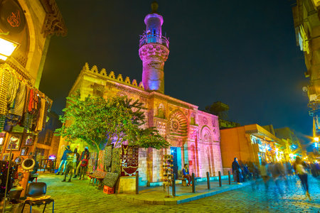 CAIRO, EGYPT - DECEMBER 20, 2017: The Al Aqmar mosque with beautiful night illumination located on the most busiest pedestrian street in old Cairo, on December 20 in Cairo.のeditorial素材