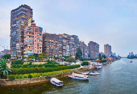 GIZA, EGYPT - DECEMBER 19, 2017: The residential high-rises of Al Doqi neighborhood and the line of...