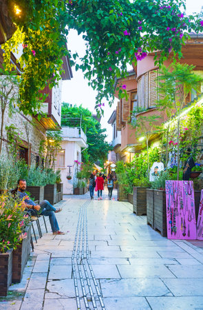 ANTALYA, TURKEY - MAY 9, 2017: The pleasant evening walk along the narrow green alley with blooming bushes of bouganivillea, souvenir and antique stores, tourist cafes and bars, on May 9 in Antalya.のeditorial素材