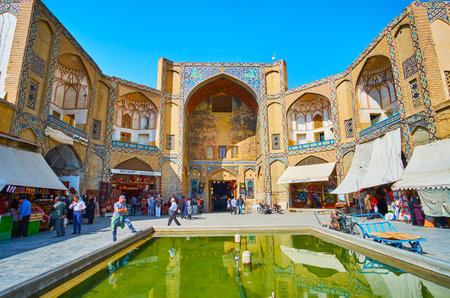 ISFAHAN, IRAN - OCTOBER 21, 2017: The medieval Qeysarie Gate of Grand (Soltani) Bazaar with ornate...