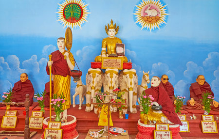 BAGO, MYANMAR - FEBRUARY 15, 2018: Interior of the shrine of Shwe Gu Lay Pagoda with statue of Lord Buddha on three elephants and Bhikkhu monks around him, on February 15 in Bago.のeditorial素材