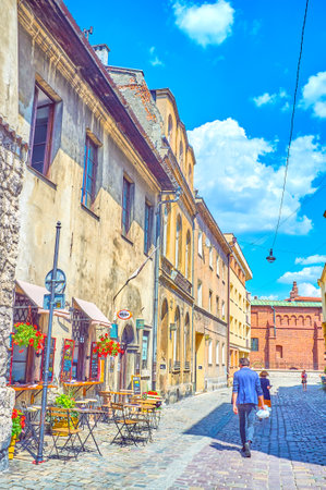 KRAKOW, POLAND - JUNE 21, 2018: The street in Kazimierz district with old edifices and small cozy...