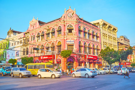 YANGON, MYANMAR - FEBRUARY 15, 2018: The busy Downtown street with preserved British Colonial style...