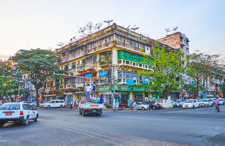 YANGON, MYANMAR - FEBRUARY 15, 2018: The wide Anawrahta road with a view on shabby residential...